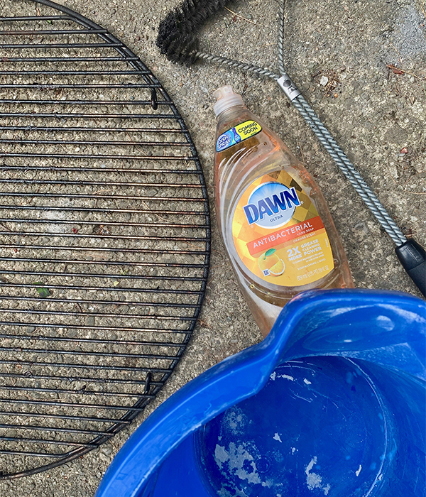 Supplies needed to Prepare your Grill for summer, such as Dawn Antibacterial Hand Soap, a Bucket, and a Grill Brush