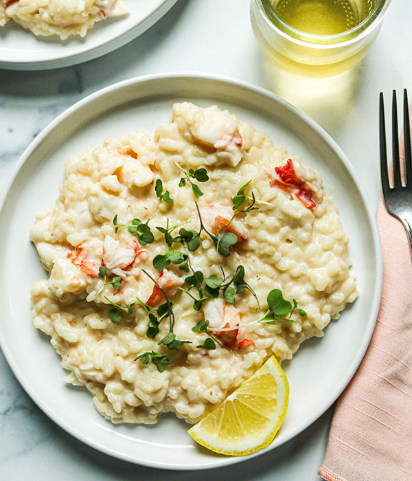 Easy Lobster Risotto on a Plate with a Glass of White Wine