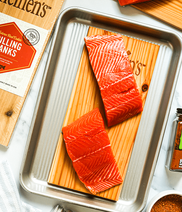 Raw Salmon Fillets on a Heinen's Cedar Plank on a Metal Sheet Tray