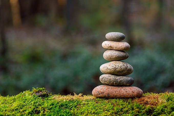 Stone pyramid on mossy ground