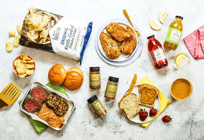 A top-down image of an assortment of Heinen's fresh and packaged Fan Favorite items on a neutral surface.