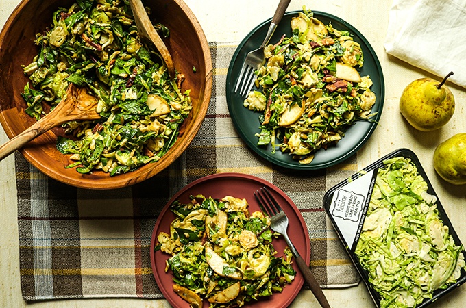 Shaved Brussel Sprouts and Pear Salad on plates and in a serving bowl