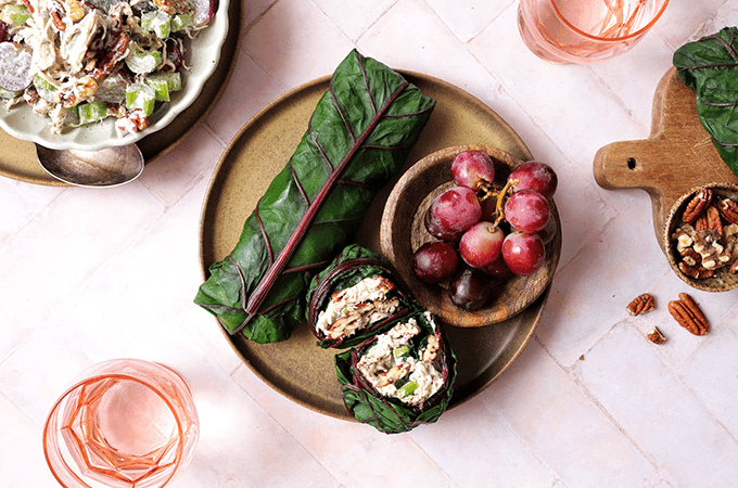 Red Chard Wrap on a Plate with a Small Bowl of Grapes