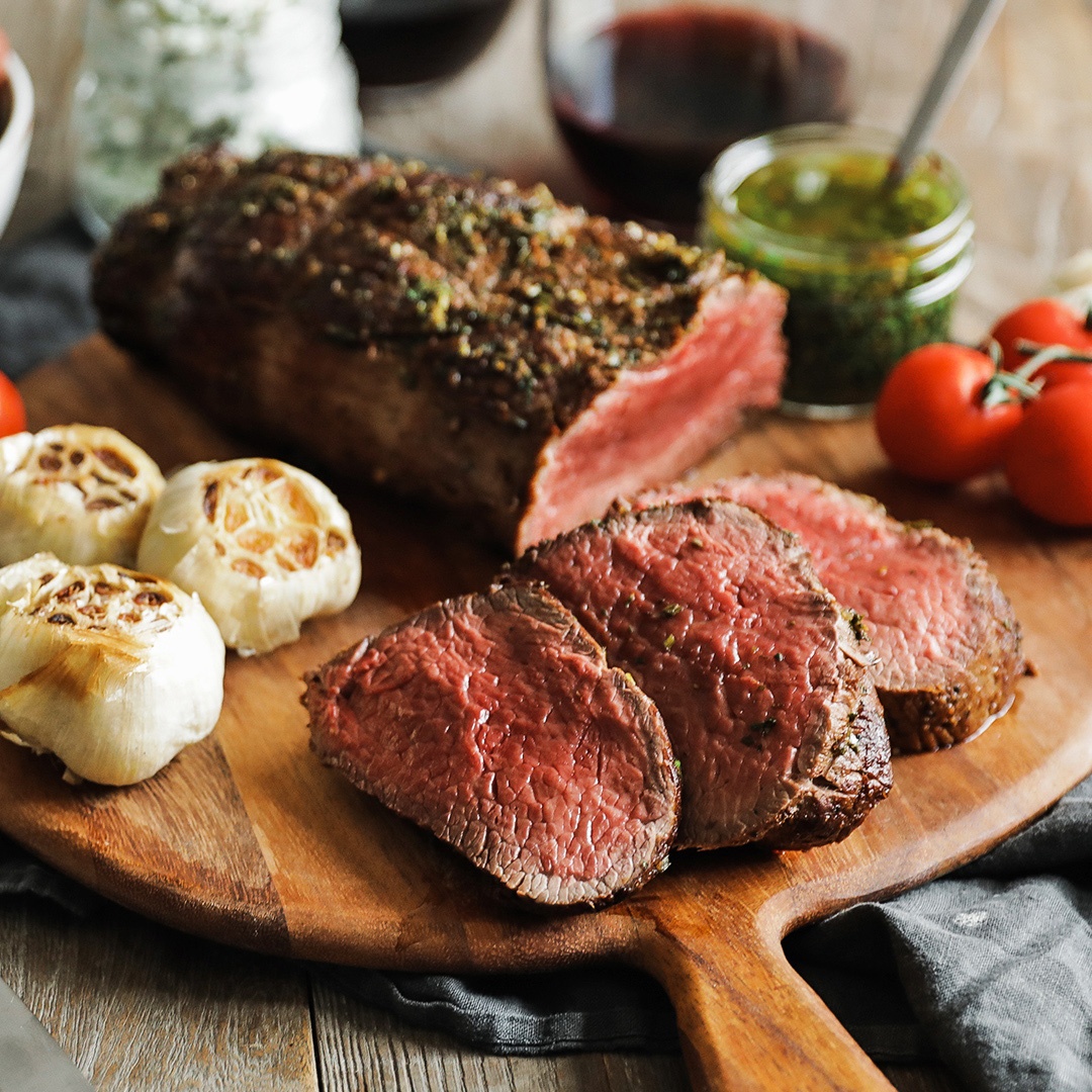 Cut steak with veggies on cutting board.