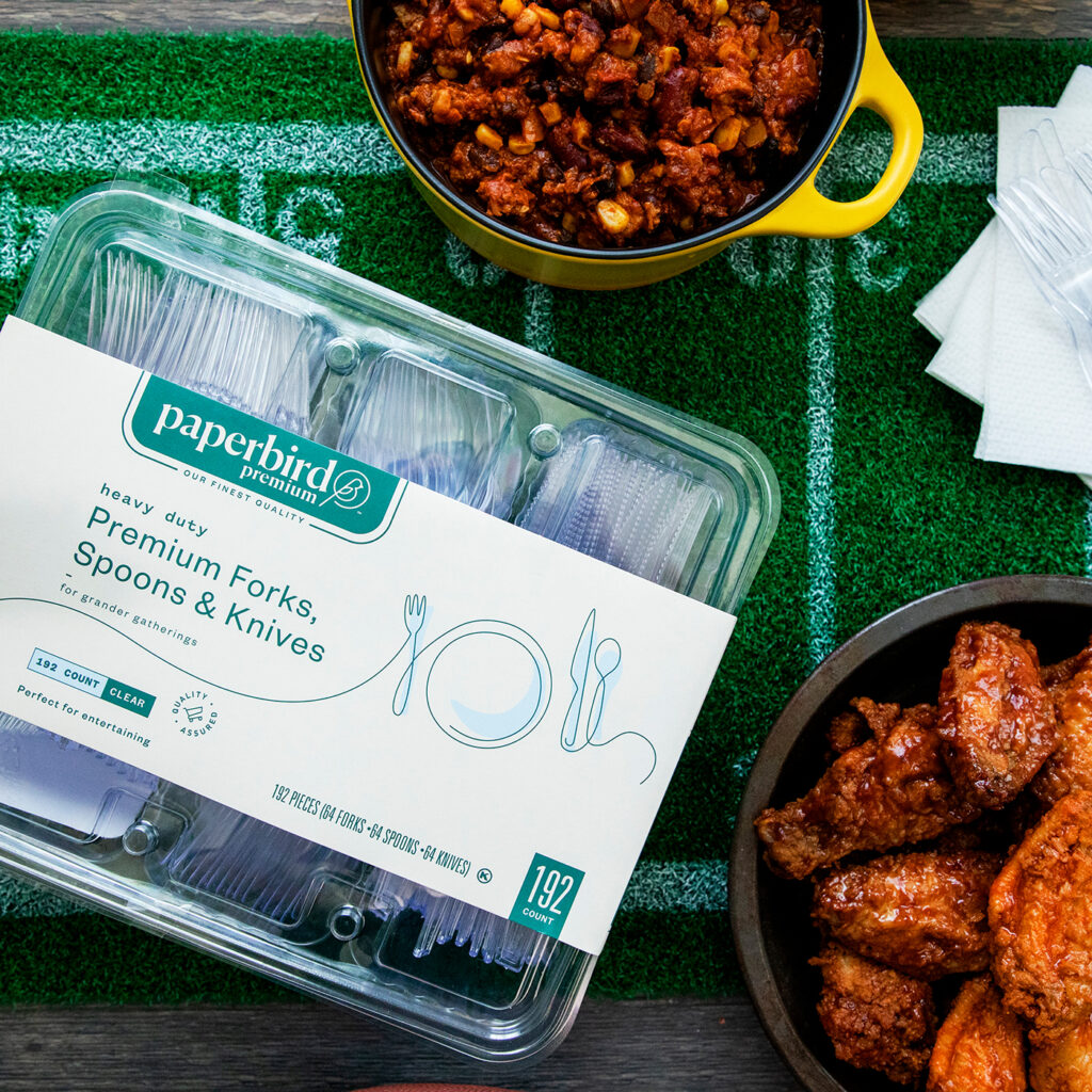 A Paperbird Heavy Duty Plastic Cutlery Set Beside Two Bowl of Chicken Wings