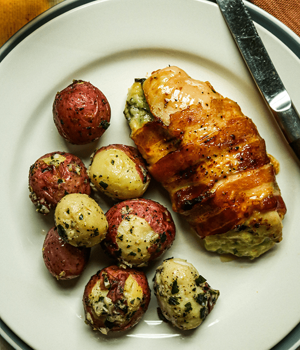 Heinen's Adams Reserve Stuffed Chicken Breast and Heinen's Garlic and Herb Roasted Potatoes on a Plate