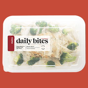 A Plastic Container of Heinen's Daily Bites Chicken, Broccoli, and Penne Alfredo Complete Meal