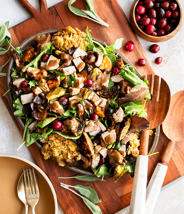 Green Salad with Turkey, Stuffing and Vegetables with a Bowl of Cranberries