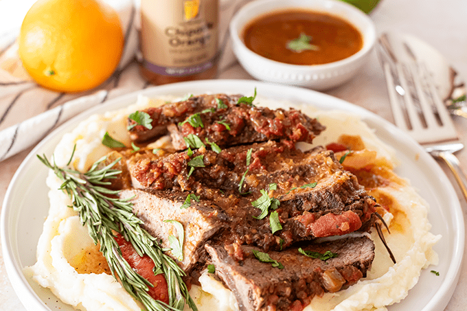 Slow Cooker Citrus Roast plated with mashed potatoes. 