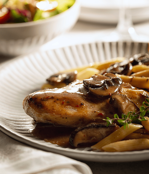 Chicken Marsala on a Serving Plate Topped with Mushrooms and Sauce