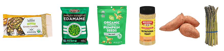 Plant-based whole foods including Heinen's green lentils, Sea Point edamame, Go Raw sprouted pumpkin seeds, Bragg nutritional yeast, sweet potatoes, and asparagus.