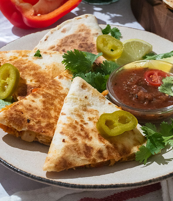 Plate of sliced classic chicken quesadillas