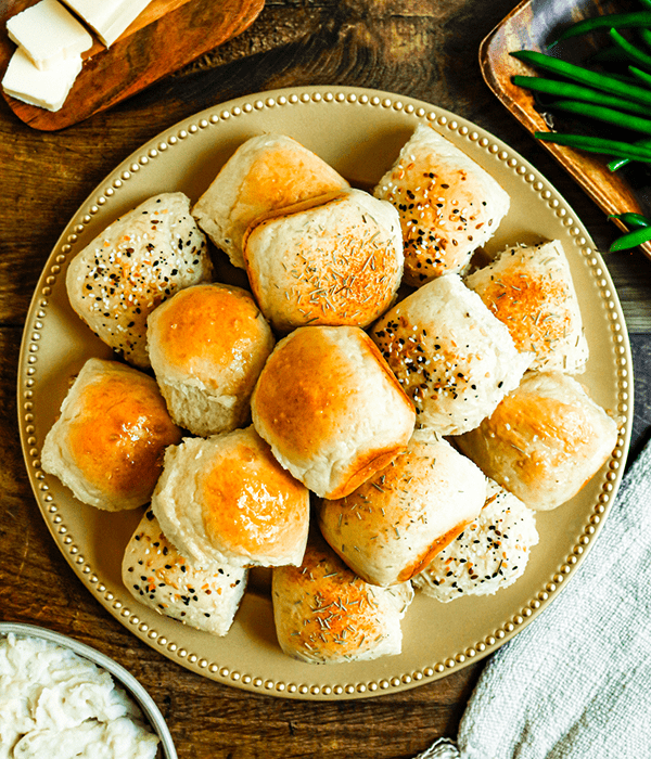 A Vertical Image of Fresh Baked Dinner Rolls on a Serving Platter
