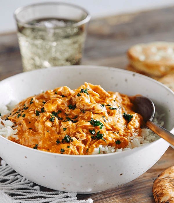Vertical Image of a Classic Butter Chicken in a White Serving Bowl